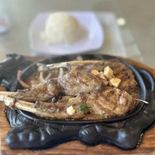 Sizzling lamb chops cooked to perfection in black peppercorns sauce and a side of garlic sauce.