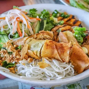 a bowl of noodles with meat and vegetables