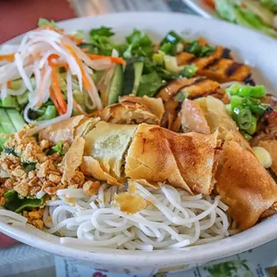 a bowl of noodles with meat and vegetables