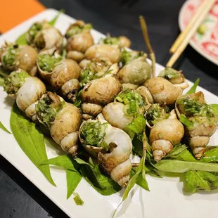 a platter of snails and lettuce