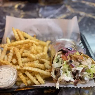 Delicious beef/lamb sandwich, spicy and a side of fries! Love the extra sauce they give!