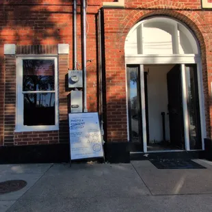 Entrance. Look for the black door with the coffee cup on it.