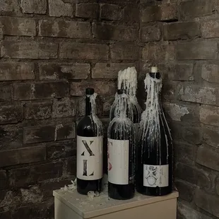 three bottles of wine on a counter