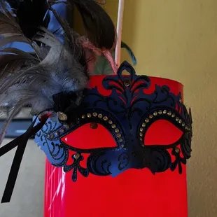 a red bucket with a mask hanging from it