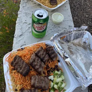 a plate of food and a can of soda