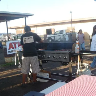 a man and a woman grilling