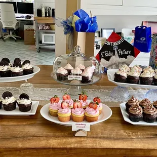 Cookies &amp; Cream, Strawberry Lemonade, Red Velvet, and Chocolate, and my daughter's Rocky Horror mortar board decor as a backdrop. Lol!