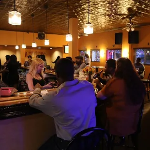 a group of people at a bar