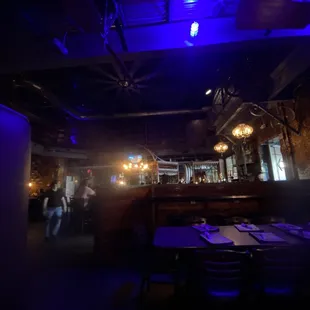 a view of a dark restaurant with blue lighting
