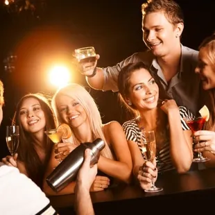a group of people drinking wine
