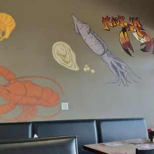 Banquette side with tables, murals