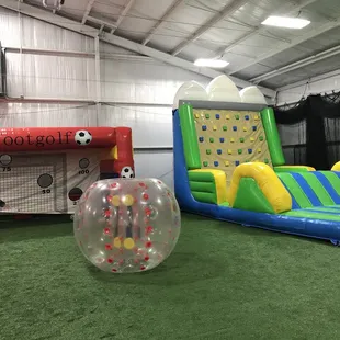 Soccer goal and inflatable climbing wall and slide.