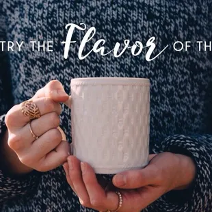 a woman holding a mug with the words try the flavor of the day