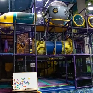 The Quest is a spectacular, multi-storied, indoor play piece consisting of tunnels, tubes, slides, and various physical challenges for kids