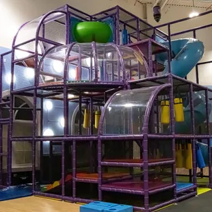 The Quest is a spectacular, multi-storied, indoor play piece consisting of tunnels, tubes, slides, and various physical challenges for kids.