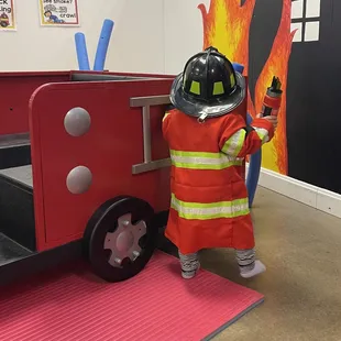Firefighter station with costumes and fire truck! Super cute!