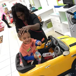 Ms. Cynthia giving our 2yr old a haircut. She was fast, professional &amp; very personable!! He loved her!!