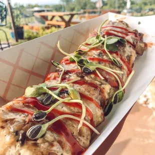 a hand holding a hot dog