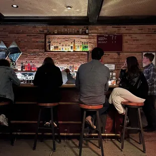 a group of people sitting at a bar