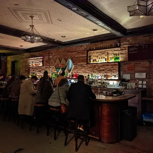 a group of people sitting at a bar