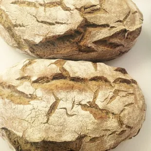 two loafs of bread on a cutting board