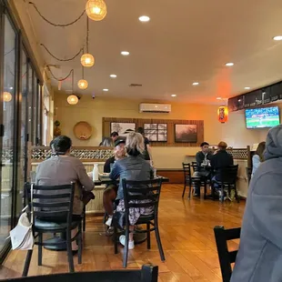 people sitting at tables in a restaurant