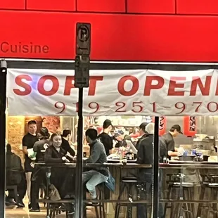 a group of people sitting outside a restaurant