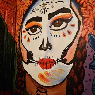 a woman&apos;s face painted on a wall