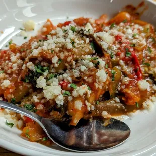 a plate of pasta and a spoon
