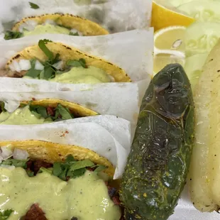 a variety of tacos and a pickle