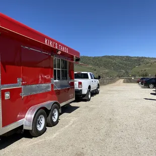 a red food truck parked in a parking lot