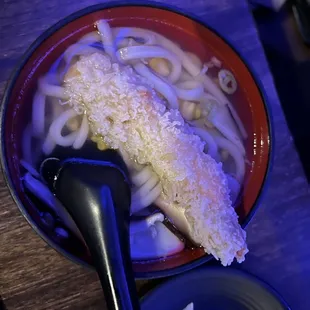 a bowl of noodles and a piece of bread