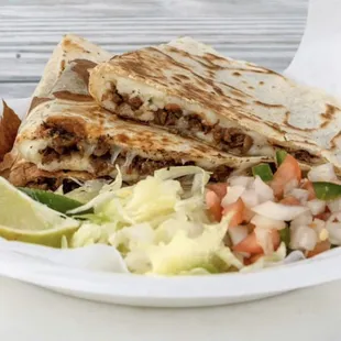 12 inch Quesadilla with any choice of meat and on the side a lettuce ,pico de gallo, avocado,sourcream and limes