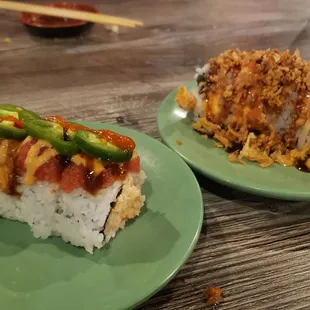 two plates of sushi on a table