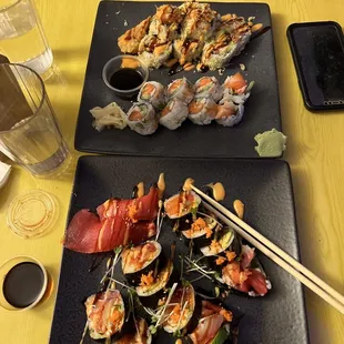 two plates of sushi and chopsticks