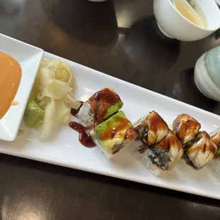 a plate of sushi with sauce