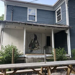 Outdoor seating area, wall art.