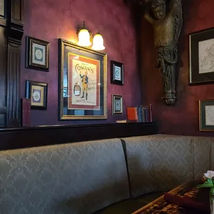 a corner booth with a vase of flowers