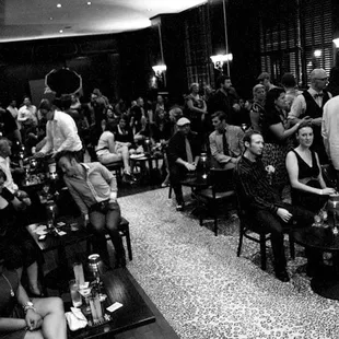 a large group of people sitting and standing around