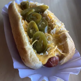 Kill devil dog with nacho cheese, shredded cheese and pickled jalapeños