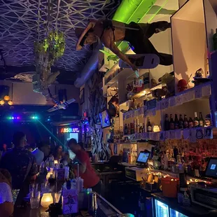 a man falling from the ceiling of a bar