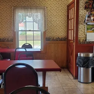 Three tables seat 4 people each and 2 two top tables in back.