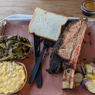 Bbq beef rib plate with creamed corn and collard greens