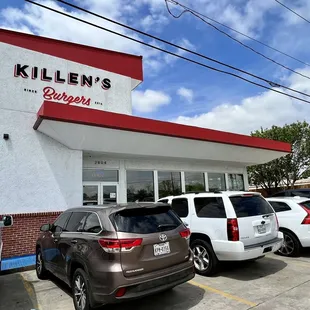 cars parked in front of a restaurant