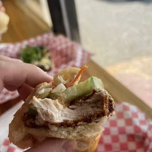 a hand holding a sandwich