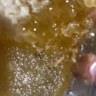 a hand holding a piece of honey