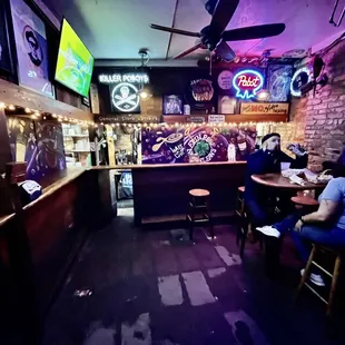 people sitting at tables in a bar