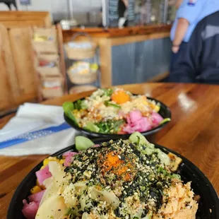 two plates of food on a wooden table