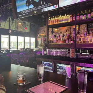 a bar with a large screen tv