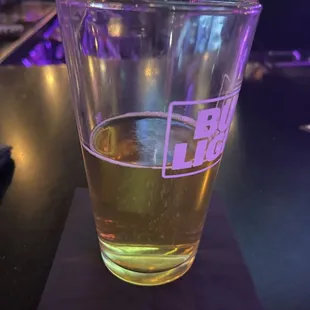 a glass of beer on a coaster